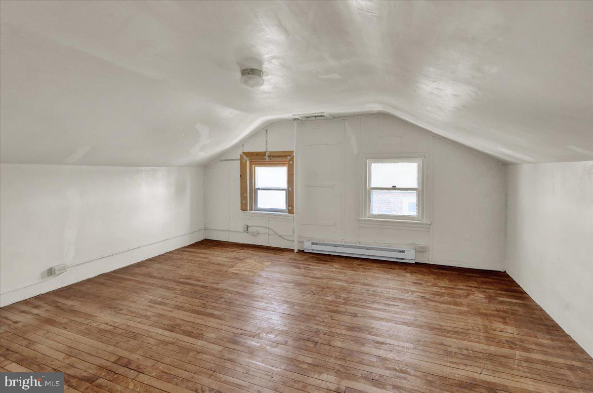 224 Hanley Place Reading, PA 19611 - Photo 17 of 19 a view of an empty room with wooden floor and a window