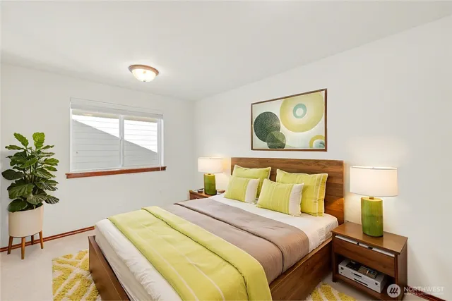 a bedroom with a bed and a potted plant