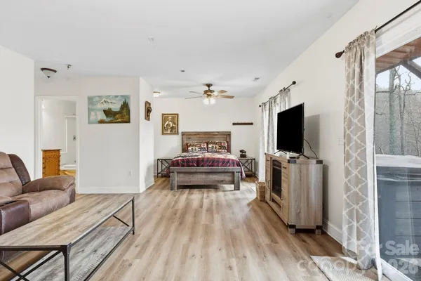 a bedroom with furniture and a flat screen tv