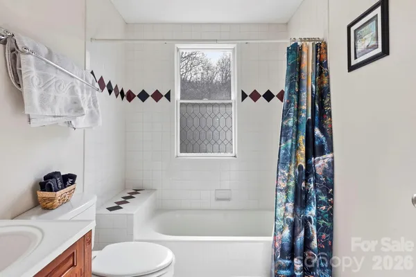 a bathroom with a bathtub shower sink and toilet