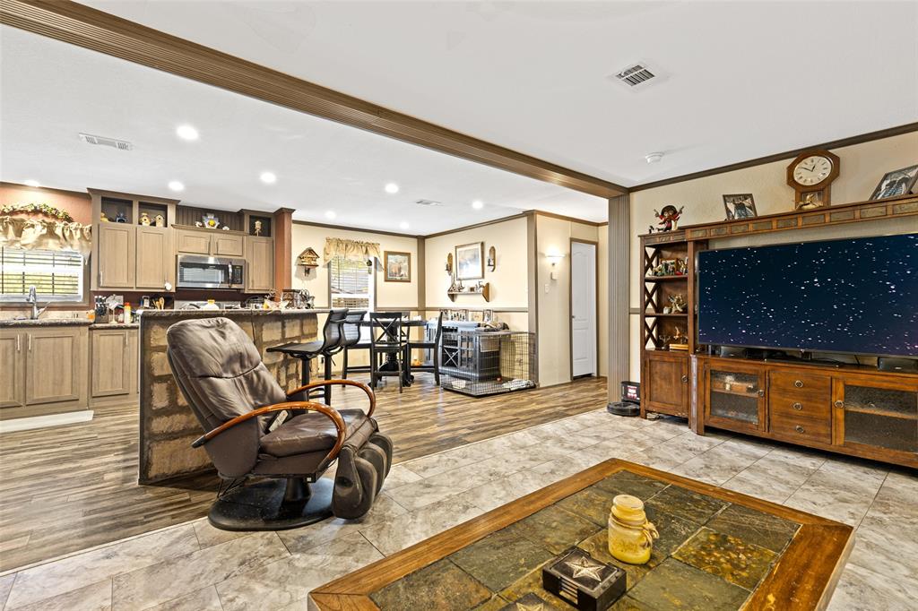 454 Geronimo Quitman, TX 75783 - Photo 12 of 37 a living room with furniture a flat screen tv and kitchen view