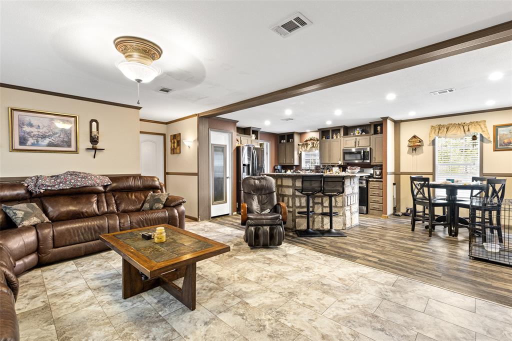 454 Geronimo Quitman, TX 75783 - Photo 15 of 37 a living room with lots of furniture and kitchen view