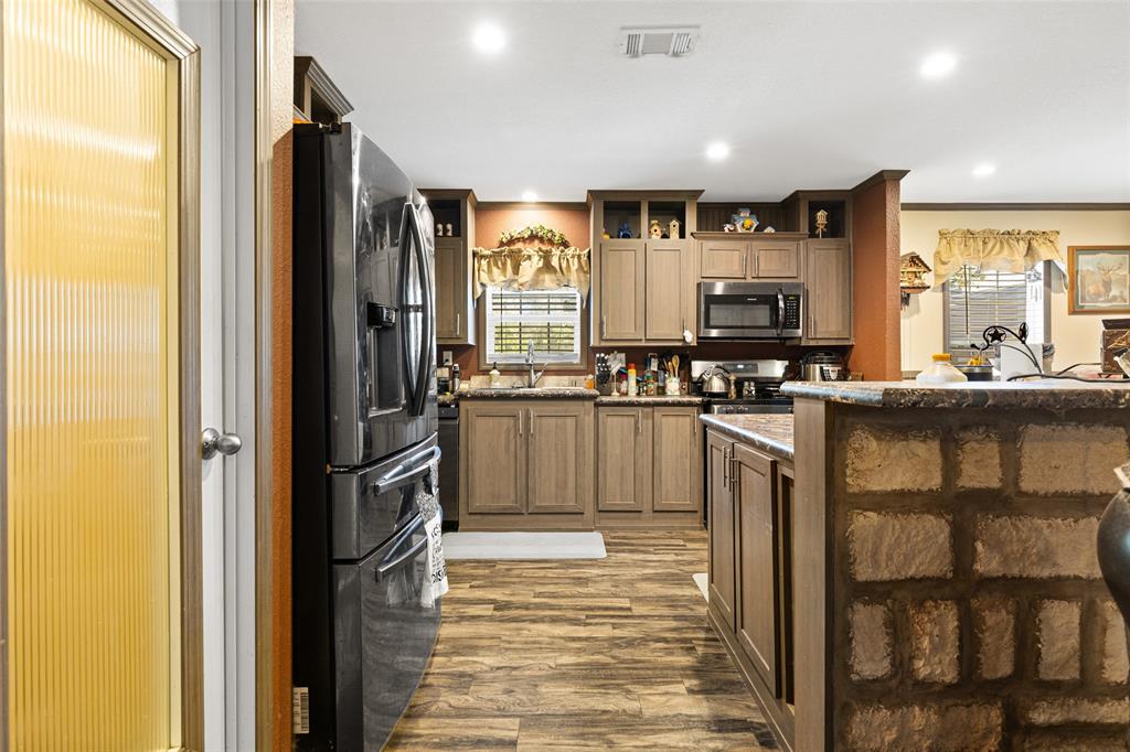 454 Geronimo Quitman, TX 75783 - Photo 17 of 37 a kitchen with stainless steel appliances a refrigerator and a stove top oven