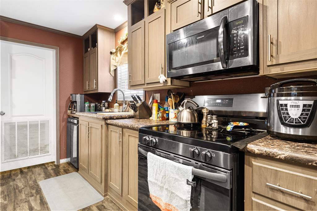 454 Geronimo Quitman, TX 75783 - Photo 19 of 37 a kitchen with stainless steel appliances granite countertop a stove a sink and a microwave