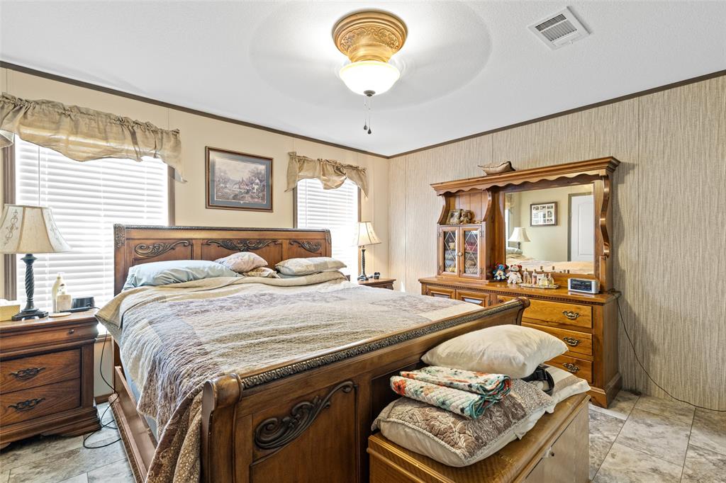 454 Geronimo Quitman, TX 75783 - Photo 22 of 37 a bedroom with a bed and wooden floor