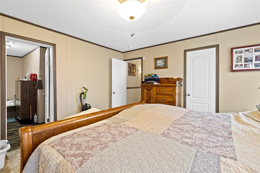 454 Geronimo Quitman, TX 75783 - Photo 23 of 37 a bedroom with a bed and dresser with mirror