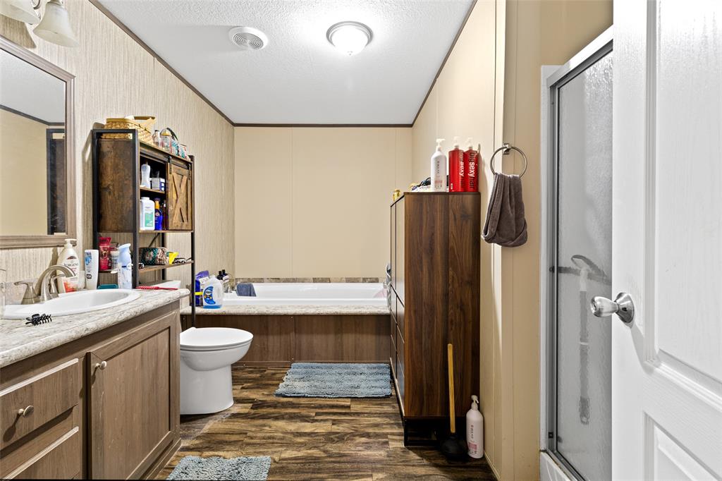 454 Geronimo Quitman, TX 75783 - Photo 24 of 37 a bathroom with a sink vanity mirror and shower