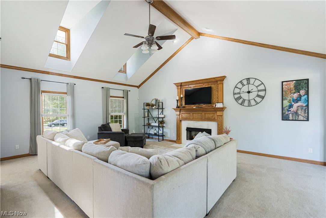 939 Pontius Road Mogadore, OH 44260 - Photo 10 of 35 Carpeted living room with vaulted ceiling high, ceiling fan, and beamed ceiling