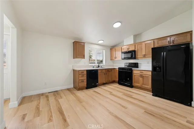 a kitchen with a refrigerator and a sink