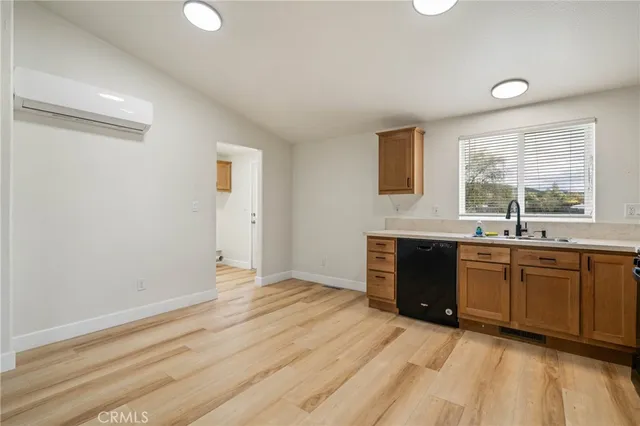 a kitchen with granite countertop a stove a sink and a refrigerator