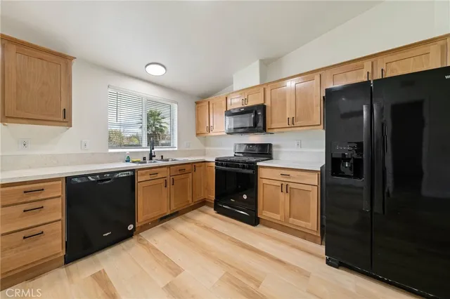 a kitchen with a refrigerator stove and sink