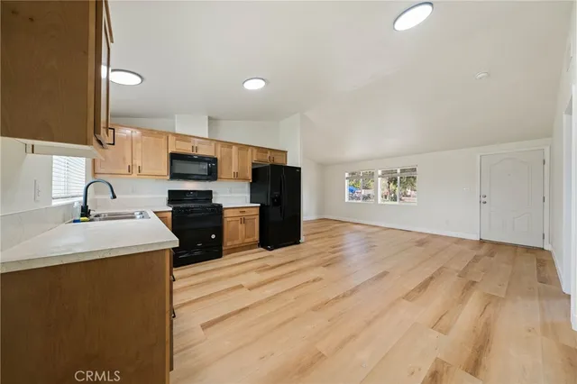 a kitchen with stainless steel appliances a sink stove and cabinets