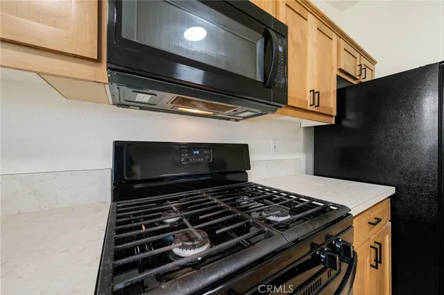a stove top oven sitting inside of a kitchen