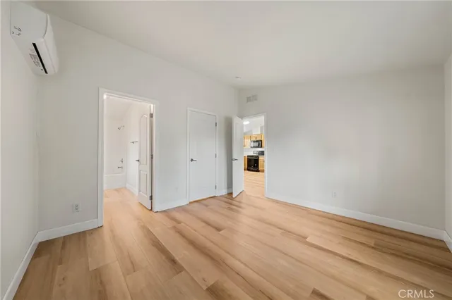 a view of an empty room and wooden floor