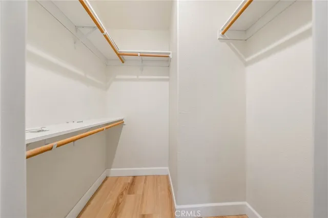 a view of closet with wooden floor