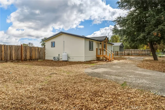 a view of backyard of house and car parked