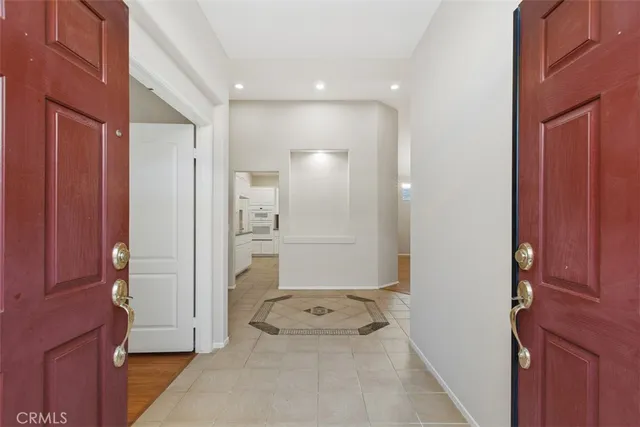 a view of a hallway with bathroom and a shower