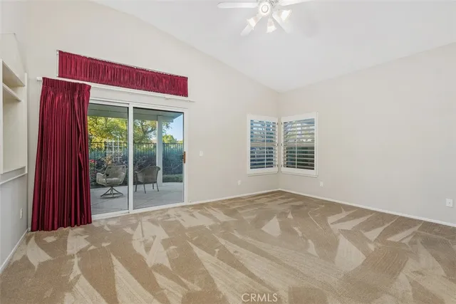an empty room with a bathroom and a window