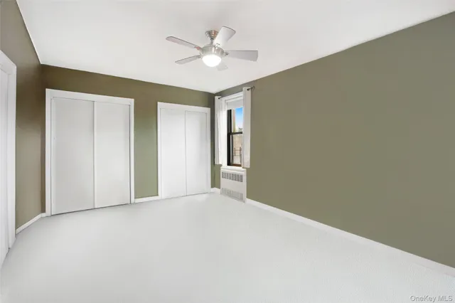 a view of an empty room with a ceiling fan