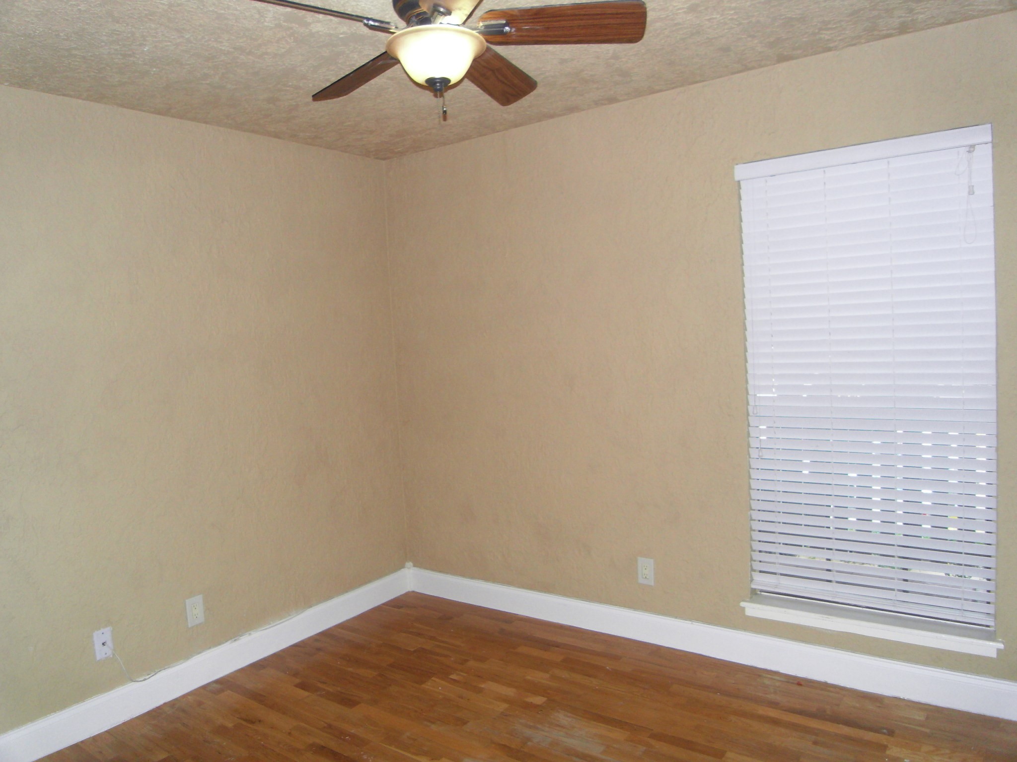 14911 Wunderlich Drive, Unit 1108 Houston, TX 77069 - Photo 16 of 26 an empty room with wooden floor and windows