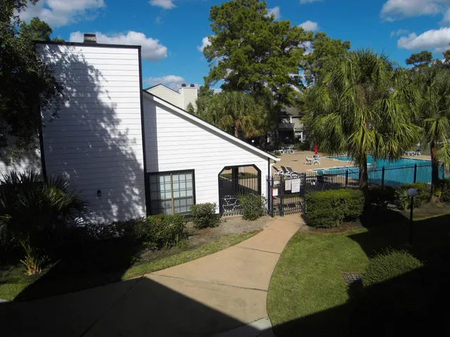a view of a house with pool table and chairs