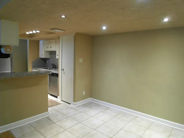 a kitchen with granite countertop a stove and a microwave