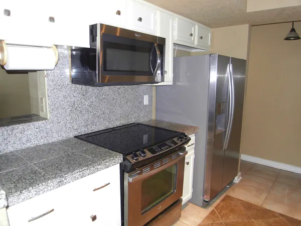 a view of a room with a window and wooden floor