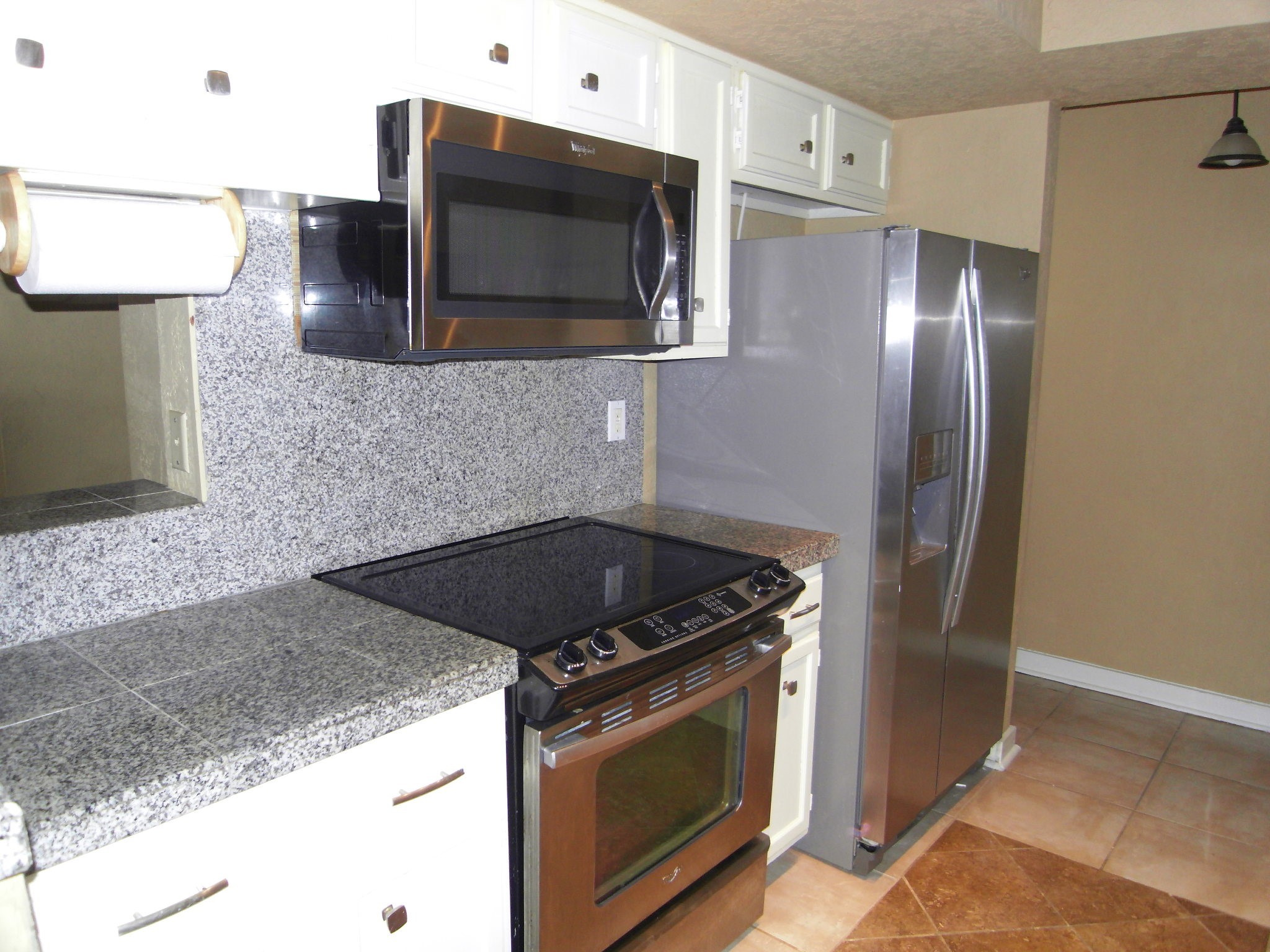14911 Wunderlich Drive, Unit 1108 Houston, TX 77069 - Photo 10 of 26 a kitchen with granite countertop a sink and stainless steel appliances