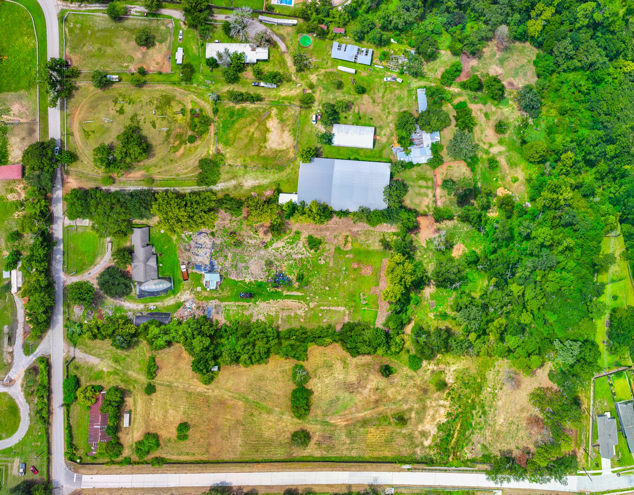25635 Hufsmith Cemetery Road Tomball, TX 77375 - Photo 15 of 50 From a higher altitude, this aerial beautifully reveals how well-positioned this extraordinary Tomball acreage is within the Greater Houston landscape — surrounded by established neighborhoods and growing development corridors, yet offering the rare combination of open land and existing on-site improvements that sophisticated land buyers have been seeking.
