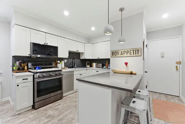 a kitchen with granite countertop a sink appliances and cabinets