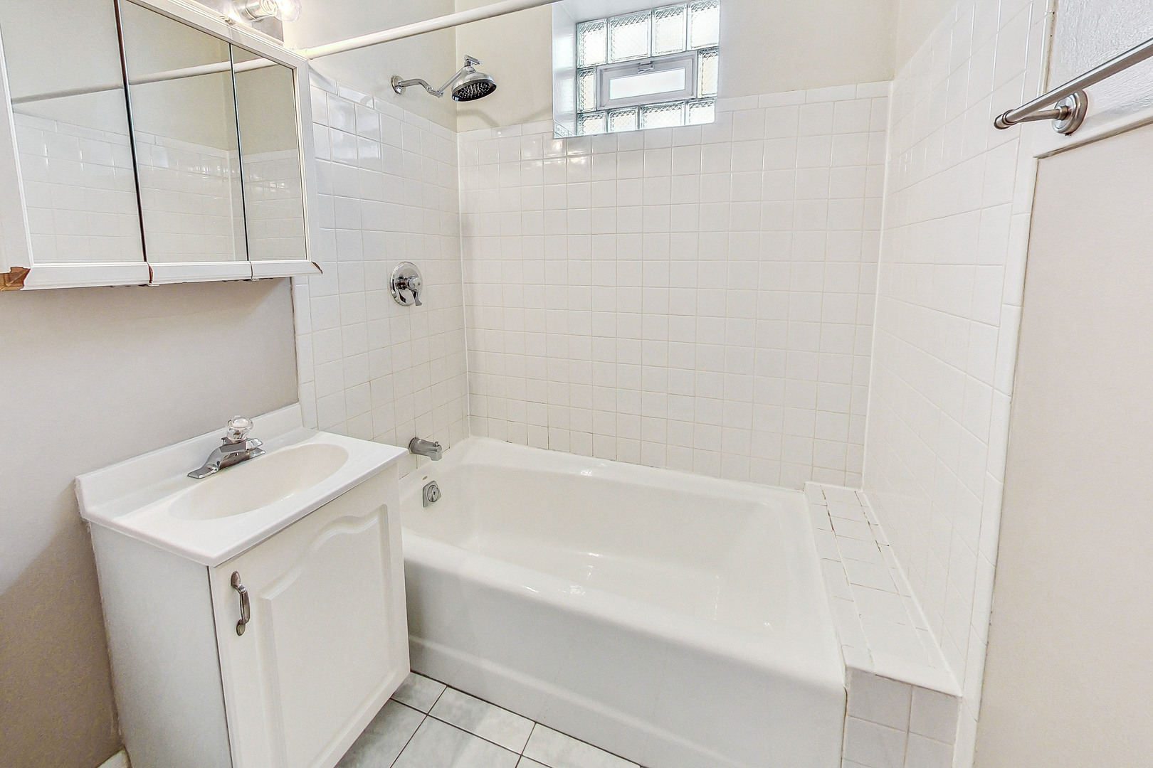 1312 West Nelson Street, Unit 3 Chicago, IL 60657 - Photo 12 of 15 a bathroom with a sink a bath tub and a shower