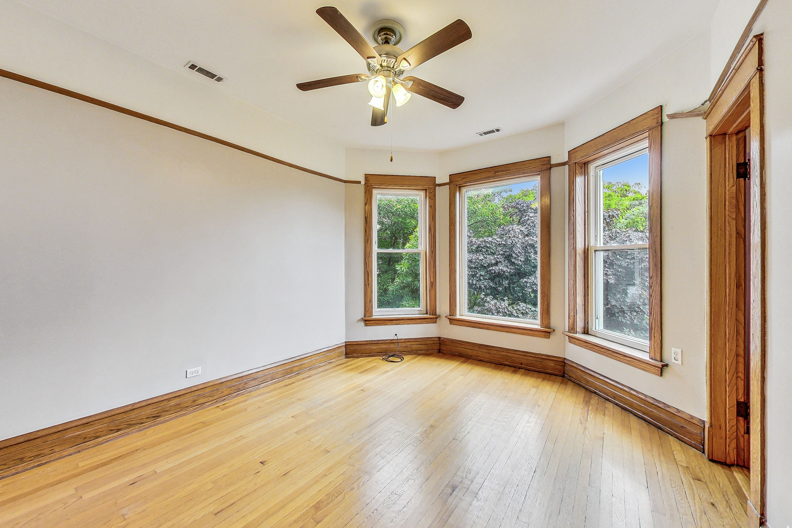 1312 West Nelson Street, Unit 3 Chicago, IL 60657 - Photo 2 of 15 a view of an empty room with a window and wooden floor
