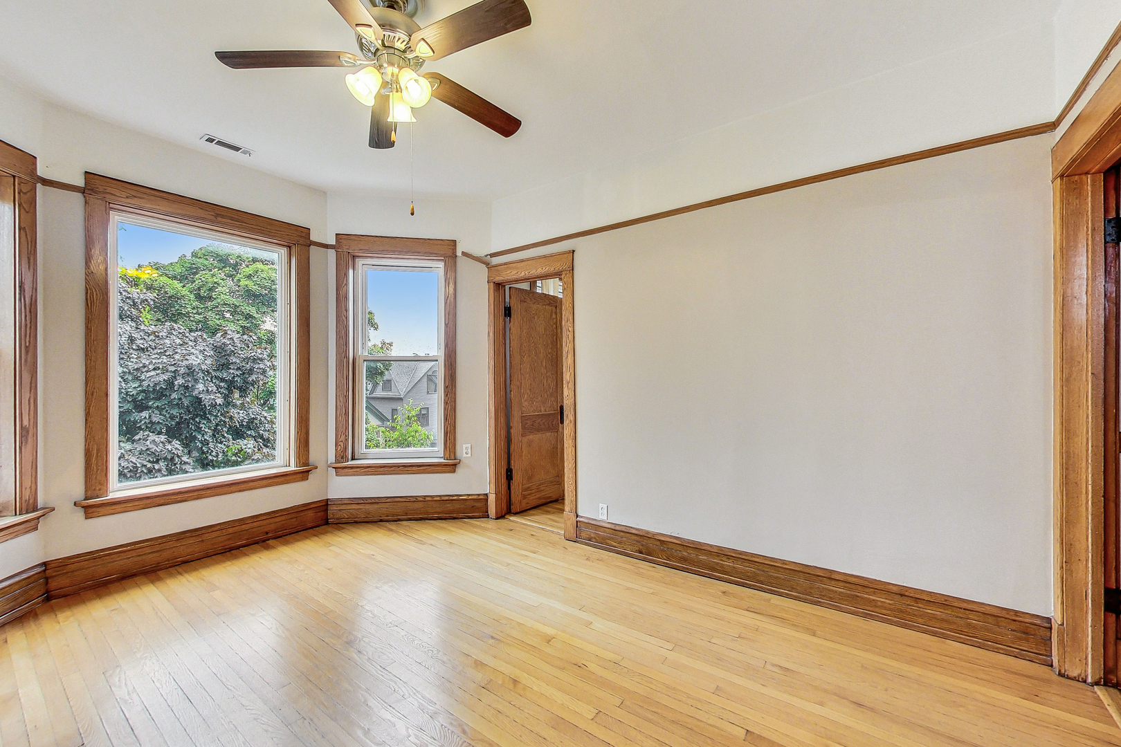 1312 West Nelson Street, Unit 3 Chicago, IL 60657 - Photo 4 of 15 a view of an empty room with a window and wooden floor