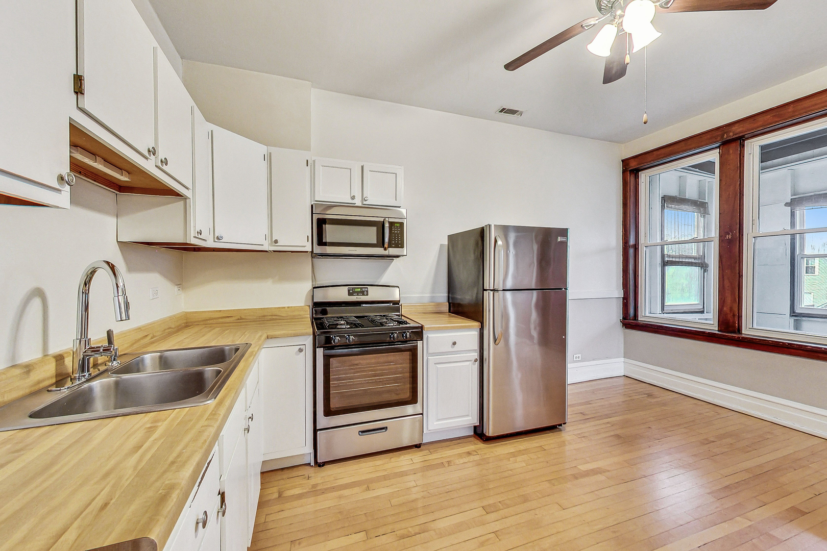 1312 West Nelson Street, Unit 3 Chicago, IL 60657 - Photo 6 of 15 a kitchen with stainless steel appliances granite countertop a refrigerator sink and stove