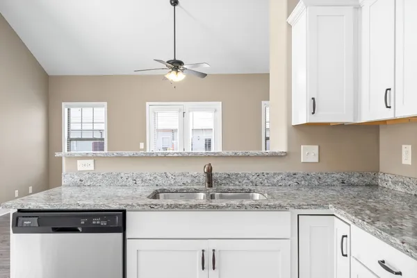 a kitchen with stainless steel appliances granite countertop a sink stove and cabinets