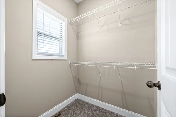 a view of a small space with wooden floor and a window