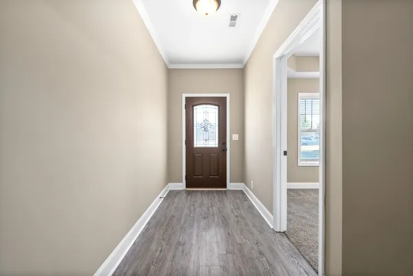 a view of a hallway with wooden floor