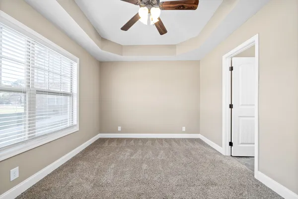 a view of room with window and ceiling fan