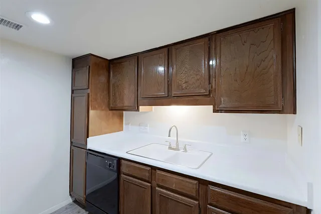 a kitchen with a sink and cabinets