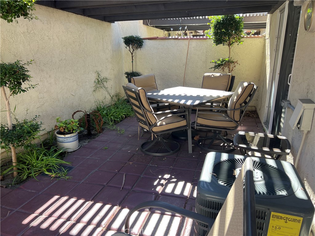 525 San Marcos Road San Dimas, CA 91773 - Photo 12 of 22 a view of a patio with table and chairs potted plants with wooden floor