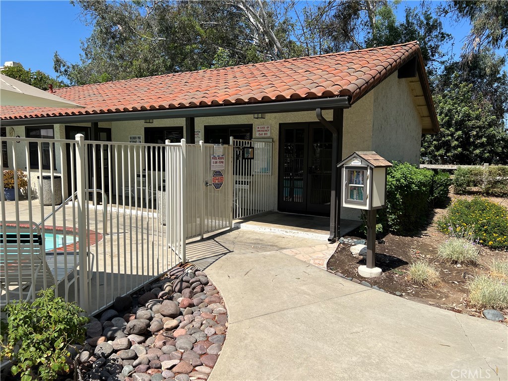 525 San Marcos Road San Dimas, CA 91773 - Photo 18 of 22 a view of a house with a wooden bench in a patio