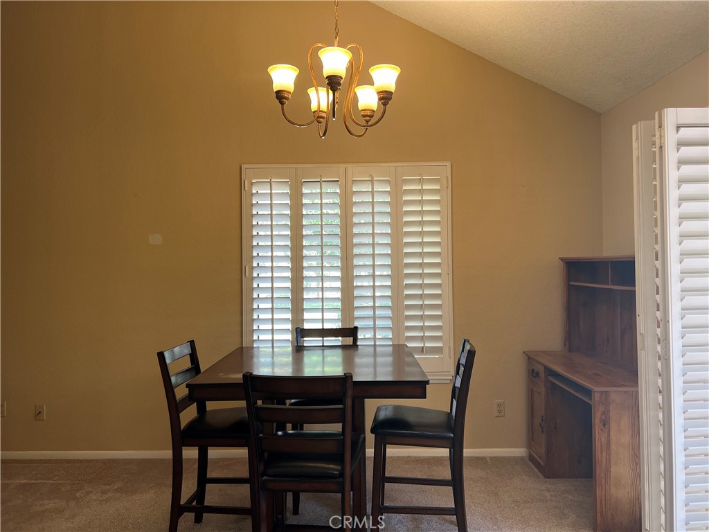 525 San Marcos Road San Dimas, CA 91773 - Photo 7 of 22 a view of a dining room with furniture and a chandelier