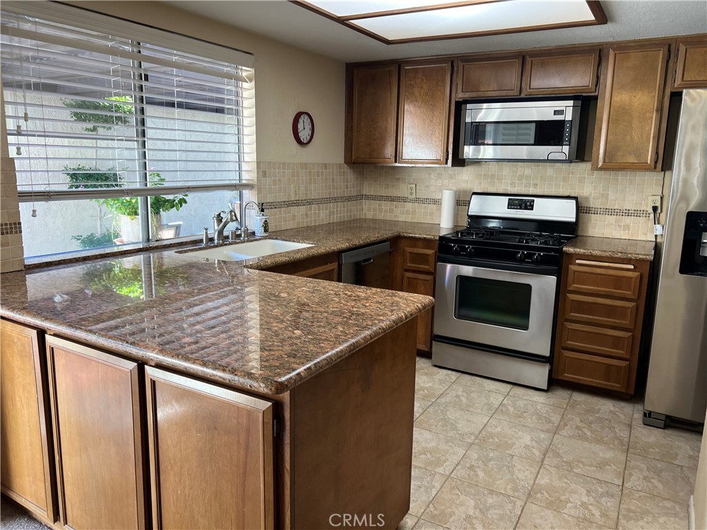 525 San Marcos Road San Dimas, CA 91773 - Photo 8 of 22 a kitchen with stainless steel appliances granite countertop a sink stove and microwave