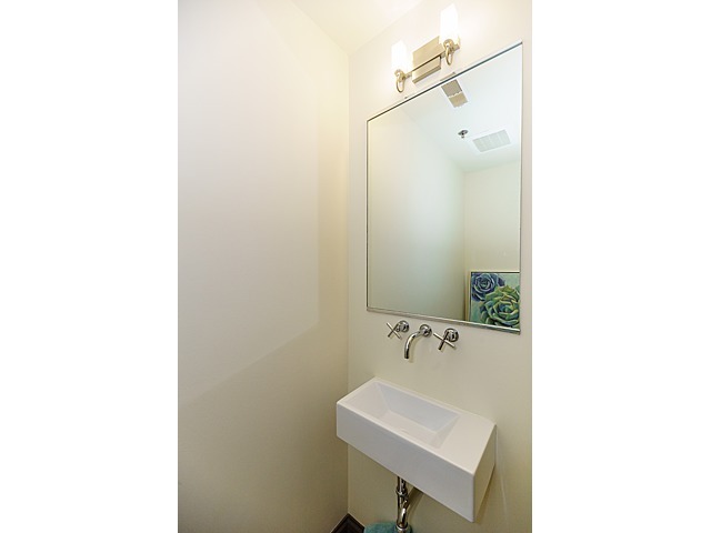 106 North Aberdeen Street, Unit 4B Chicago, IL 60607 - Photo 11 of 17 a bathroom with a sink a mirror and a toilet