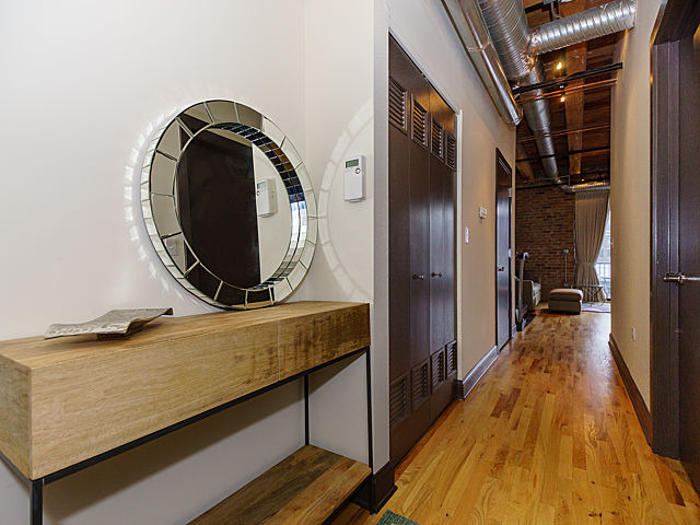 106 North Aberdeen Street, Unit 4B Chicago, IL 60607 - Photo 16 of 17 a view of a hallway with wooden floor