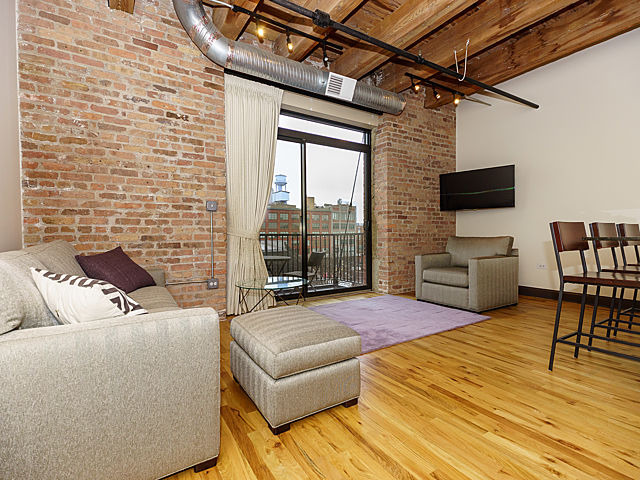 106 North Aberdeen Street, Unit 4B Chicago, IL 60607 - Photo 4 of 17 a bedroom with furniture and a flat screen tv