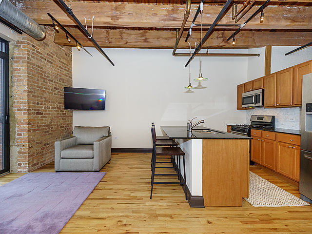 106 North Aberdeen Street, Unit 4B Chicago, IL 60607 - Photo 5 of 17 a living room with furniture and a wooden floor