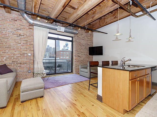 106 North Aberdeen Street, Unit 4B Chicago, IL 60607 - Photo 6 of 17 a view of a livingroom with furniture and wooden floor