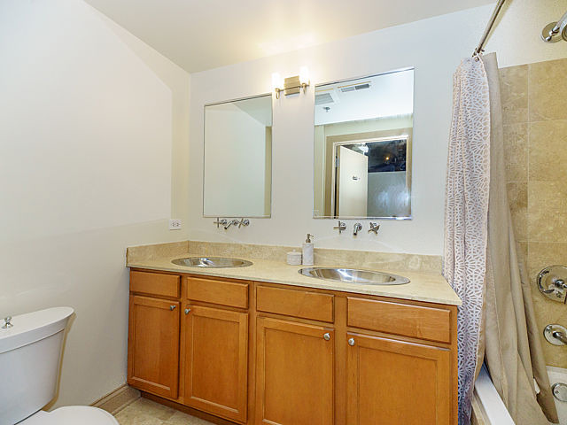 106 North Aberdeen Street, Unit 4B Chicago, IL 60607 - Photo 10 of 17 a bathroom with a granite countertop sink toilet and mirror