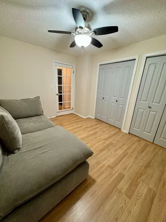 a bedroom with a bed and a ceiling fan